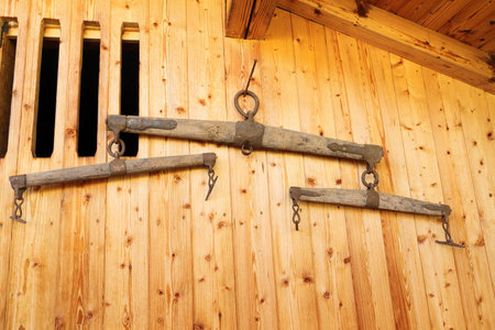 an old wooden wall with an old agricultural toolの写真素材