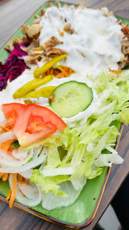 kebab plate with salad and sauceの写真素材
