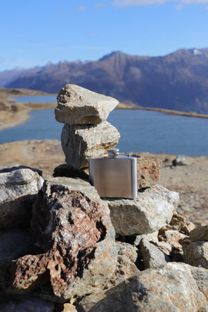 a hip flask while walking on stonesの写真素材