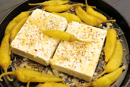 Baked feta cheese with peppersの写真素材