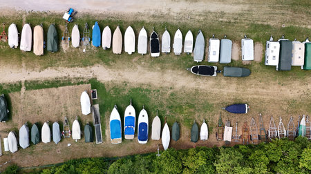 Trailer with boats on a parking space â€“ drone aerial photography
