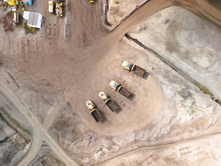 Aerial View of Construction Site with Heavy Equipment and Dump Trucks â€“ Industrial...