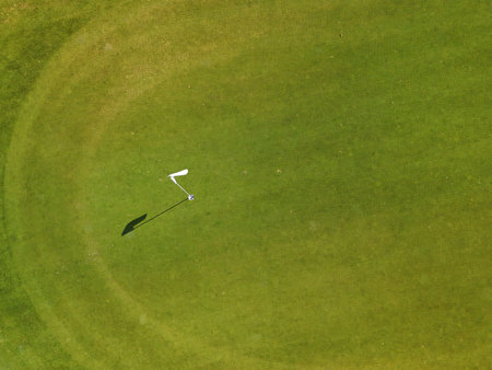 Aerial view of a green golf course with fairways