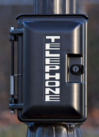 Emergency telephone on a post. This particular phone is along a trail that circles a reservoir.の写真素材