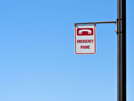 Emergency phone sign with a blue sky backgroundの写真素材