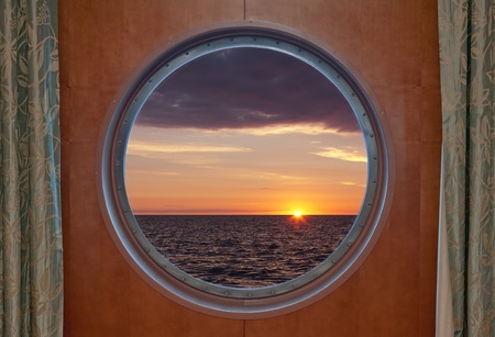 View of a sunrise through a cruise ship windowの写真素材