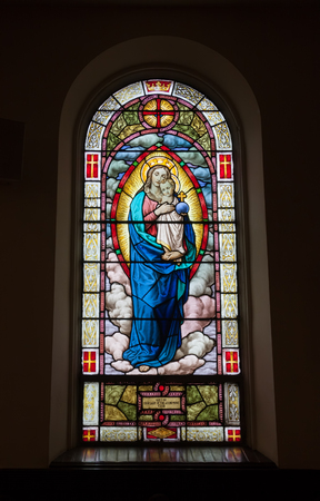 A religious stained glass window inside a churchのeditorial素材