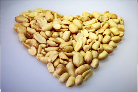 salted peanuts ripe grains on a white table