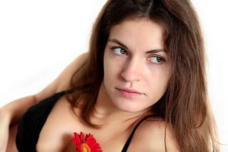 Young woman with red flowerの写真素材