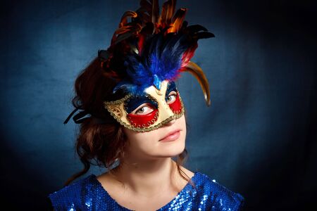 Young woman in carnival mask