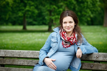 Beautiful pregnant woman in the park
