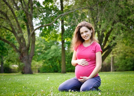 Beautiful pregnant woman in the parkの写真素材