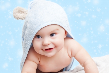 Smiling baby with towel on winter backgroundの写真素材