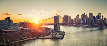 Panoramic view of Brooklyn bridge and Manhattan at sunset, New York Cityのeditorial素材