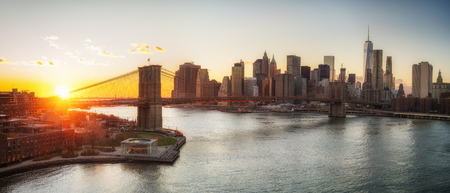Panoramic view of Brooklyn bridge and Manhattan at sunset, New York Cityのeditorial素材