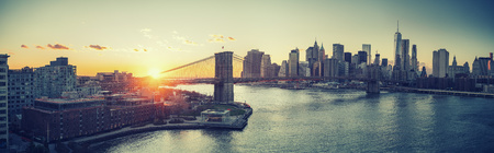 Panoramic view of Brooklyn bridge and Manhattan at sunset, New York Cityの写真素材