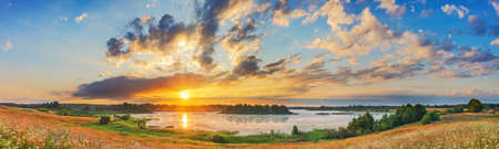 Beautiful landscape with colorful sunset over forest lake