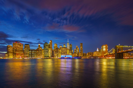 Panoramic view on Manhattan and Brooklyn bridge at dusk, New York Cityの写真素材
