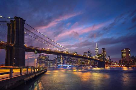 Panoramic view on Brooklyn bridge and Manhattan at dusk, New York Cityの写真素材