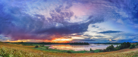 Beautiful landscape with colorful sunset over forest lakeの写真素材