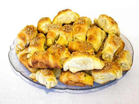 Lot of salty croissants with cheese and sesame.