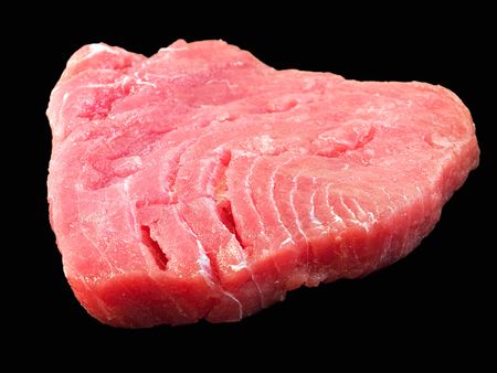 Fresh tuna steak isolated on a black background.の写真素材