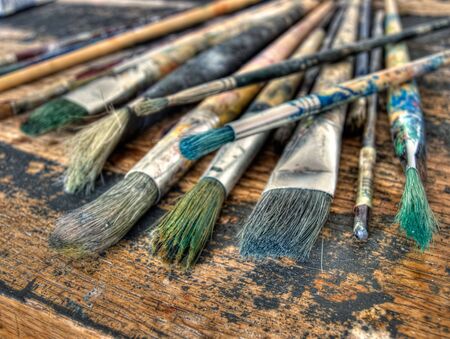 Closeup of used brushes and colors in one art studio.の写真素材