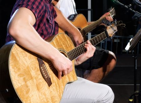 Detail of two guitar players on stage during the concert.の写真素材