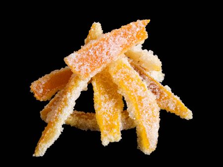 Homemade candied lemon and orange peel isolated on a black background.の写真素材