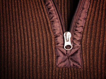 Closeup view on the zipper on a brown sweater ...の写真素材
