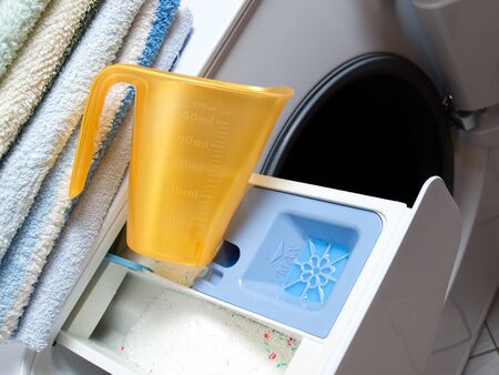 Closeup view of measuring cup and  tub for dispensing detergent in a washing machine...の写真素材