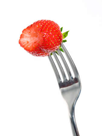Strawberry on fork isolated on white background.の写真素材