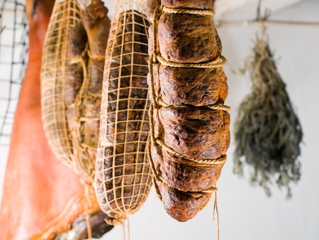 Domestic smoked meat products produced in the traditional way in an old smokehouse. の写真素材