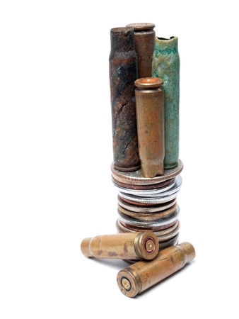 Old bullet cartridges and various coins represent the economic causes of war の写真素材