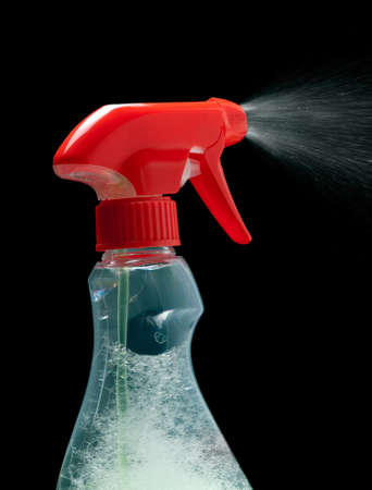 Cleaning spray bottle on a black background の写真素材