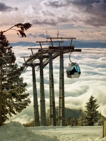 Sight on the cableway infrastructure over foggy valley の写真素材