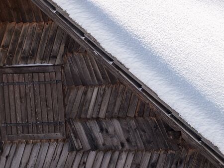 Detail of an old wooden snow shack somewhere in mountains の写真素材