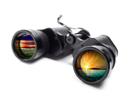 Binoculars on a white background with different seascape on each lens.