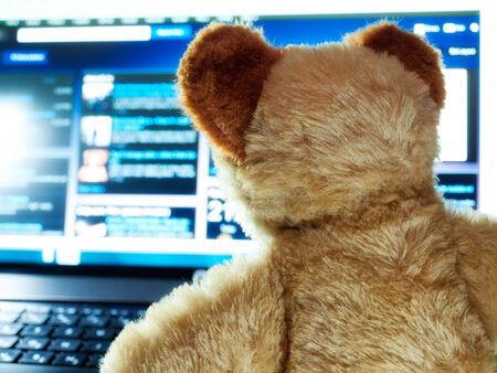 Teddy bear as an Internet user.の写真素材