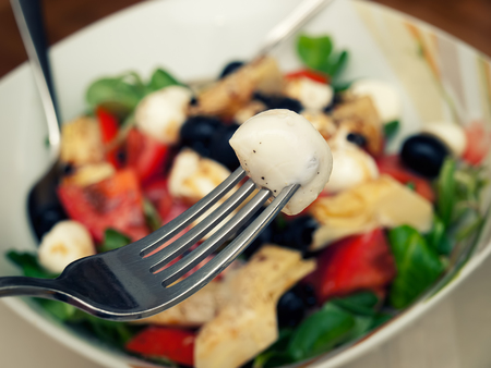 Closeup view of a bowl full of Mozzarella salad.の写真素材