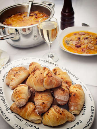 Salty rolls and a pot of homemade food.