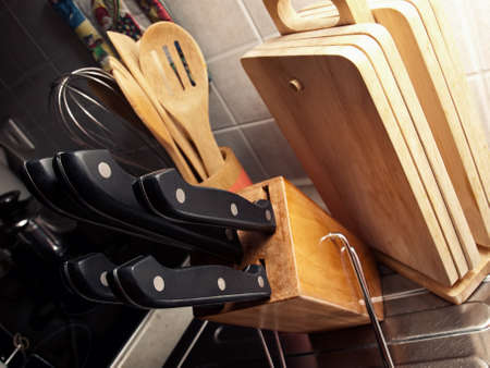 Detail from the home kitchen with a set of knives in the foreground.の写真素材