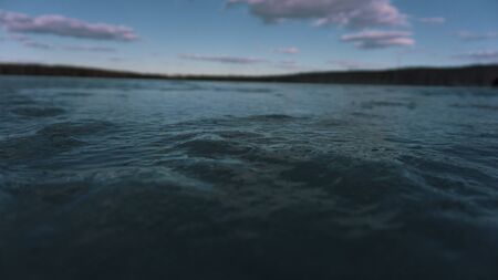 the turquoise sky and the ice of a frozen pond lake