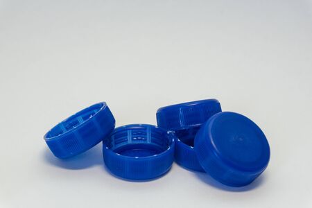 blue plastic bottle caps on a white backgroundの写真素材