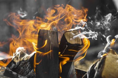 wood is burning in the grill. grill with coals