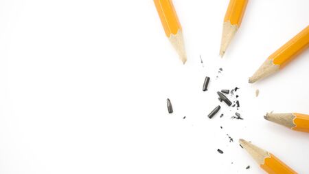 broken pencils are lying on a white backgroundの写真素材
