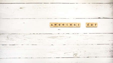day of sweets. wooden cubes with letters photoの写真素材