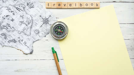 travel book. compass blank sheet of paper photo