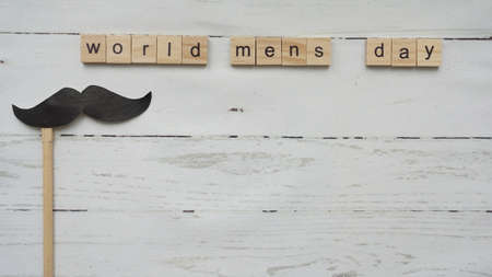 World mens day. lettering cleaning mask mustache gifts heart on a beautiful backgroundの写真素材