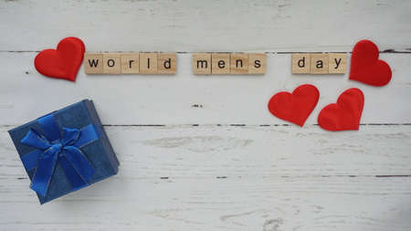 World mens day. lettering cleaning mask mustache gifts heart on a beautiful backgroundの写真素材